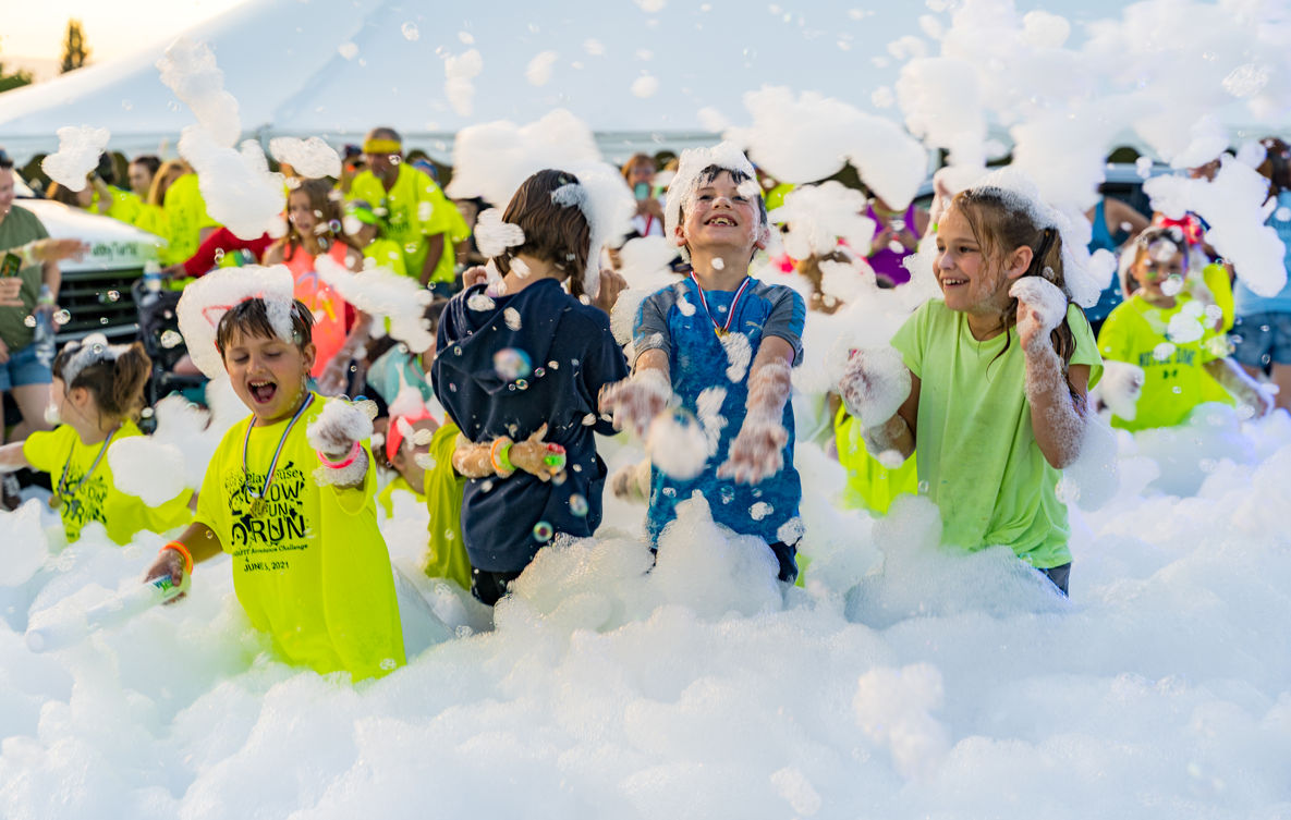 Kids running through foam